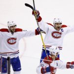 Montreal Canadiens left wing Phillip Danault (24), left wing Max Pacioretty (67), and defenseman Andrei Markov (79) celebrate a goal by Alexander Radulov against the Arizona Coyotes during the third period of an NHL hockey game Thursday, Feb. 9, 2017, in Glendale, Ariz. The Canadiens defeated the Coyotes 5-4 in overtime. (AP Photo/Ross D. Franklin)