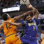 New Orleans Pelicans guard Tyreke Evans (1) is denied by Phoenix Suns forward TJ Warren (12) as he goes to the basket in the first half of an NBA basketball game in New Orleans, Monday, Feb. 6, 2017. (AP Photo/Gerald Herbert)