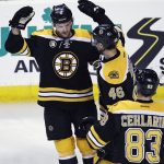 Boston Bruins defenseman Colin Miller, left, is congratulated after his goal during the first period of the team's NHL hockey game against the Arizona Coyotes in Boston, Tuesday, Feb. 28, 2017. (AP Photo/Charles Krupa)
