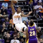 Phoenix Suns forward Marquese Chriss (0) dunks over Los Angeles Lakers center Tarik Black (28) during the first half of an NBA basketball game, Wednesday, Feb. 15, 2017, in Phoenix. (AP Photo/Matt York)