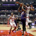 Chicago Bulls' Dwyane Wade, right, tries to block the shot of Phoenix Suns' Derrick Jones Jr. (10) during the first half of an NBA basketball game Friday, Feb. 24, 2017, in Chicago. (AP Photo/Charles Rex Arbogast)