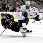 San Jose Sharks center Joe Thornton, right, knocks the puck away from Arizona Coyotes right wing Shane Doan during the third period of an NHL hockey game in Glendale, Ariz., Saturday, Feb. 18, 2017. (AP Photo/Chris Carlson)