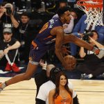 Phoenix Suns forward Derrick Jones Jr., leaps over three people during the slam-dunk contest as part of the NBA All-Star Saturday Night events in New Orleans, Saturday, Feb. 18, 2017. (AP Photo/Max Becherer)