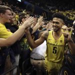 Oregon's Tyler Dorsey, right, celebrates with Duck fans after helping defeat Arizona in an NCAA college basketball game Saturday, Feb. 4, 2017, in Eugene, Ore. (AP Photo/Chris Pietsch)