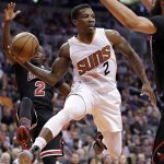 Phoenix Suns guard Eric Bledsoe (2) passes as Chicago Bulls center Robin Lopez, right, and guard Jerian Grant, rear, defend during the second half of an NBA basketball game, Friday, Feb. 10, 2017, in Phoenix. (AP Photo/Matt York)