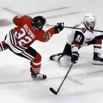 Chicago Blackhawks defenseman Michal Rozsival (32) shoots and scores a goal as Arizona Coyotes center Alexander Burmistrov (91) defends him during the second period of an NHL hockey game Thursday, Feb. 23, 2017, in Chicago. (AP Photo/David Banks)