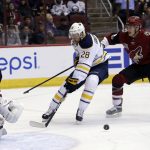 Buffalo Sabres center Zemgus Girgensons (28) drives on Arizona Coyotes goalie Louis Domingue (35) as Jakob Chychrun (6) defends from behind in the first period during an NHL hockey game, Sunday, Feb. 26, 2017, in Glendale, Ariz. (AP Photo/Rick Scuteri)
