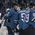 San Jose Sharks defenseman Brenden Dillon (4) celebrates with teammates after scoring a goal against the Arizona Coyotes during the second period of an NHL hockey game in San Jose, Calif., Saturday, Feb. 4, 2017. (AP Photo/Jeff Chiu)