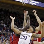Washington's Markelle Fultz (20) takes an elbow to the jaw from Arizona's Rawle Alkins (1) as they wait with Chance Comanche for a rebound during the second half of an NCAA college basketball game Saturday, Feb. 18, 2017, in Seattle. Arizona won 76-68. (AP Photo/Elaine Thompson)