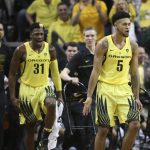 Oregon's Dylan Ennis, left, and Tyler Dorsey, right, celebrate during the second half of an NCAA college basketball game against Arizona Saturday, Feb. 4, 2017, in Eugene, Ore. (AP Photo/Chris Pietsch)