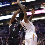 Los Angeles Clippers center DeAndre Jordan (6) fouls Phoenix Suns forward Marquese Chriss (0) during the second half of an NBA basketball game, Wednesday, Feb. 1, 2017, in Phoenix. Jordan was called for a flagrant foul and ejected from the game. (AP Photo/Matt York)