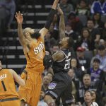 Sacramento Kings guard Ben McLemore, right, shoots over Phoenix Suns center Tyson Chandler during the first quarter of an NBA basketball game Friday, Feb. 3, 2017, in Sacramento, Calif. (AP Photo/Rich Pedroncelli)