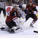 Arizona Coyotes goalie Louis Domingue (35) makes the save on Buffalo Sabres center Zemgus Girgensons (28) in the first period during an NHL hockey game, Sunday, Feb. 26, 2017, in Glendale, Ariz. (AP Photo/Rick Scuteri)