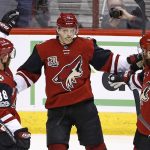 Arizona Coyotes center Christian Dvorak (18) celebrates his goal against the Montreal Canadiens with left wing Max Domi (16) and left wing Jamie McGinn (88) during the second period of an NHL hockey game Thursday, Feb. 9, 2017, in Glendale, Ariz. (AP Photo/Ross D. Franklin)