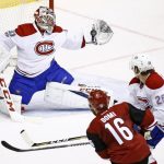 Montreal Canadiens goalie Carey Price (31) makes a glove-save on a shot by Arizona Coyotes left wing Max Domi (16) as Canadiens defenseman Jeff Petry (26) defends during the second period of an NHL hockey game Thursday, Feb. 9, 2017, in Glendale, Ariz. (AP Photo/Ross D. Franklin)