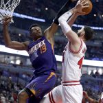 Phoenix Suns' Leandro Barbosa (19) tries to black the shot of Chicago Bulls' Nikola Mirotic, but is called for a foul during the first half of an NBA basketball game Friday, Feb. 24, 2017, in Chicago. (AP Photo/Charles Rex Arbogast)