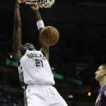 Milwaukee Bucks' Tony Snell (21) dunks in front of Phoenix Suns' Alex Len during the first half of an NBA basketball game Sunday, Feb. 26, 2017, in Milwaukee. (AP Photo/Jeffrey Phelps)