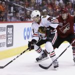 Chicago Blackhawks left wing Ryan Hartman (38) and Arizona Coyotes defenseman Michael Stone battle for the puck in the first period during an NHL hockey game, Thursday, Feb. 2, 2017, in Glendale, Ariz. (AP Photo/Rick Scuteri)