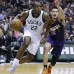 Milwaukee Bucks' Khris Middleton (22) drives against the Phoenix Suns' Devin Booker during the first half of an NBA basketball game, Sunday, Feb. 26, 2017, in Milwaukee. (AP Photo/Jeffrey Phelps)