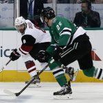 Arizona Coyotes' Tobias Rieder (8) skates the puck up ice on Dallas Stars' Brett Ritchie (25) during the first period of an NHL hockey game, Friday, Feb. 24, 2017, in Dallas. (AP Photo/Mike Stone)