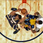 Indiana pacers Glenn Robinson III slam dunks over teammate Paul George, a mascot, and a cheerleader, as he participates in the slam dunk contest during NBA All-Star Saturday Night events in New Orleans, Saturday, Feb. 18, 2017. (AP Photo/Gerald Herbert)