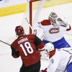 Arizona Coyotes center Christian Dvorak (18) scores a goal against Montreal Canadiens goalie Carey Price, top right, as Canadiens defenseman Shea Weber (6) is unable to help out during the second period of an NHL hockey game Thursday, Feb. 9, 2017, in Glendale, Ariz. (AP Photo/Ross D. Franklin)
