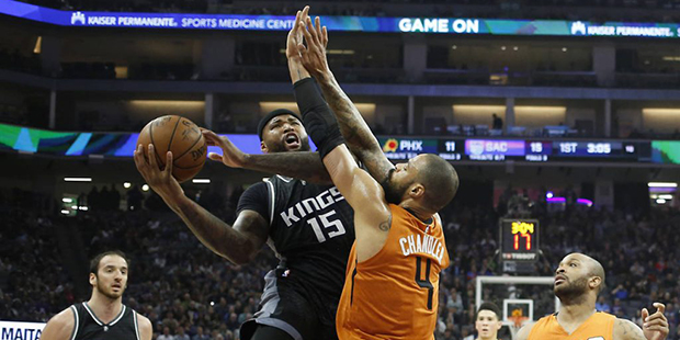 Sacramento Kings forward DeMarcus Cousins, second from left, goes to the basket against Phoenix Sun...