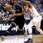 Chicago Bulls guard Dwyane Wade (3) drives past Phoenix Suns forward TJ Warren (12) during the first half of an NBA basketball game, Friday, Feb. 10, 2017, in Phoenix. (AP Photo/Matt York)