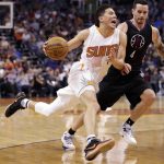 Phoenix Suns guard Devin Booker (1) drives past Los Angeles Clippers guard J.J. Redick (4) during the second half of an NBA basketball game, Wednesday, Feb. 1, 2017, in Phoenix. (AP Photo/Matt York)