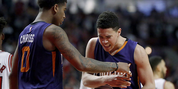 Phoenix Suns' Devin Booker, right, reacts in front of teammate Marquese Chriss after Booker missed ...