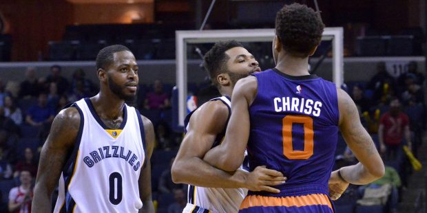Memphis Grizzlies guard Andrew Harrison, center, gets between Phoenix Suns forward Marquese Chriss ...
