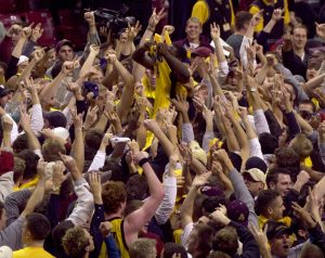 Arizona State guard Curtis Millage, center, lifts his shirt as he is raised onto the shoulders of jubilant fans after Arizona State defeated No. 10 Arizona 88-72 on Wednesday, Jan. 23, 2002, in Tempe, Ariz. (AP Photo/Paul Connors)