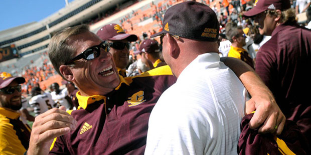 Central Michigan's Athletic Director Dave Heeke celebrates the 30-27 win over Oklahoma State with C...