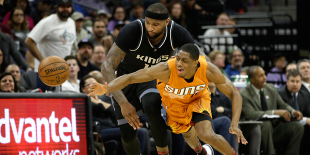 Sacramento Kings forward DeMarcus Cousins, left, and Phoenix Suns guard Brandon Knight go for the b...