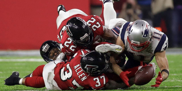 New England Patriots' Julian Edelman makes a catch as Atlanta Falcons' Ricardo Allen and Keanu Neal...