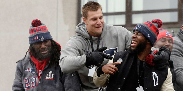 New England Patriots tight end Rob Gronkowski, center, points to running back James White alongside...
