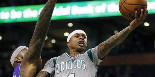 Boston Celtics' Isaiah Thomas (4) goes up to shoot against Sacramento Kings' DeMarcus Cousins durin...