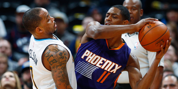 Denver Nuggets guard Jameer Nelson, left, defends as Phoenix Suns guard Brandon Knight looks to pas...