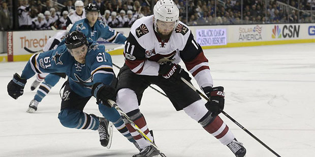 Arizona Coyotes center Martin Hanzal (11), from the Czech Republic, skates with the puck in front o...