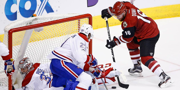 Arizona Coyotes left wing Max Domi (16) gets ready to send the puck past Montreal Canadiens center ...