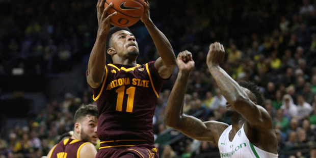Arizona State's Shannon Evans II goes to the basket against Oregon's Jordan Bell during the second ...