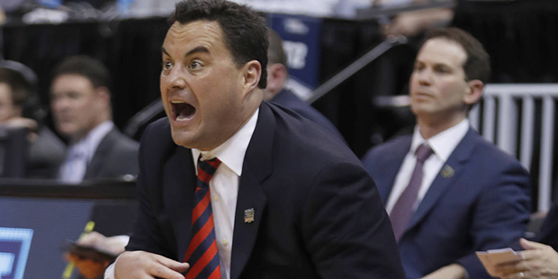 Arizona assistant Joe Pasternack (right) watches while head coach Sean Miller yells during an NCAA ...