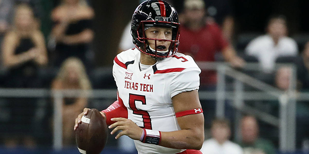 Texas Tech quarterback Patrick Mahomes (5) scrambles in the pocket before passing in the first half...