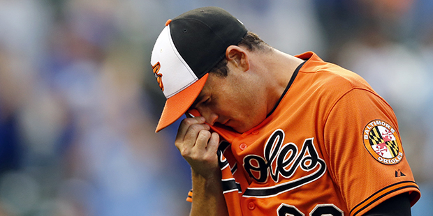 Baltimore Orioles relief pitcher T.J. McFarland walks off the field after being relieved in the sev...