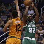 Boston Celtics forward Jae Crowder (99) shoots over Phoenix Suns forward TJ Warren in the fourth quarter during an NBA basketball game, Sunday, March 5, 2017, in Phoenix. Phoenix defeated Boston 109-106. (AP Photo/Rick Scuteri)