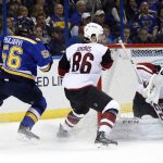 Arizona Coyotes goalie Mike Smith, right, smothers the puck as teammate Josh Jooris (86) and St. Louis Blues' Magnus Paajarvi (56) watch during the second period of an NHL hockey game Monday, March 27, 2017, in St. Louis. (AP Photo/Jeff Roberson)