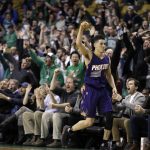 Phoenix Suns guard Devin Booker (1) gestures after he scored a basket, while fans cheer him at TD Garden in the fourth quarter of the team's NBA basketball game against the Boston Celtics, Friday, March 24, 2017, in Boston. Booker scored 70 points in the game. The Celtics won 130-120. (AP Photo/Elise Amendola)