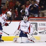 Washington Capitals' Braden Holtby, right, gives up a goal to Arizona Coyotes' Josh Jooris as Capitals' Kevin Shattenkirk (22) skates past during the first period of an NHL hockey game Friday, March 31, 2017, in Glendale, Ariz. (AP Photo/Ross D. Franklin)