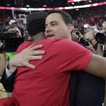 Arizona coach Sean Miller celebrates with players after Arizona defeated Oregon 83-80 in an NCAA college basketball game for the championship of the Pac-12 men's tournament Saturday, March 11, 2017, in Las Vegas. (AP Photo/John Locher)