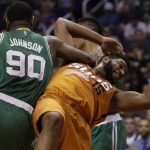 Boston Celtics forward Amir Johnson (90) and Phoenix Suns forward Alan Williams (15) get tangled up in the first quarter during an NBA basketball game, Sunday, March 5, 2017, in Phoenix. (AP Photo/Rick Scuteri)